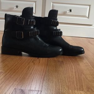 Low black leather boots with metal detail